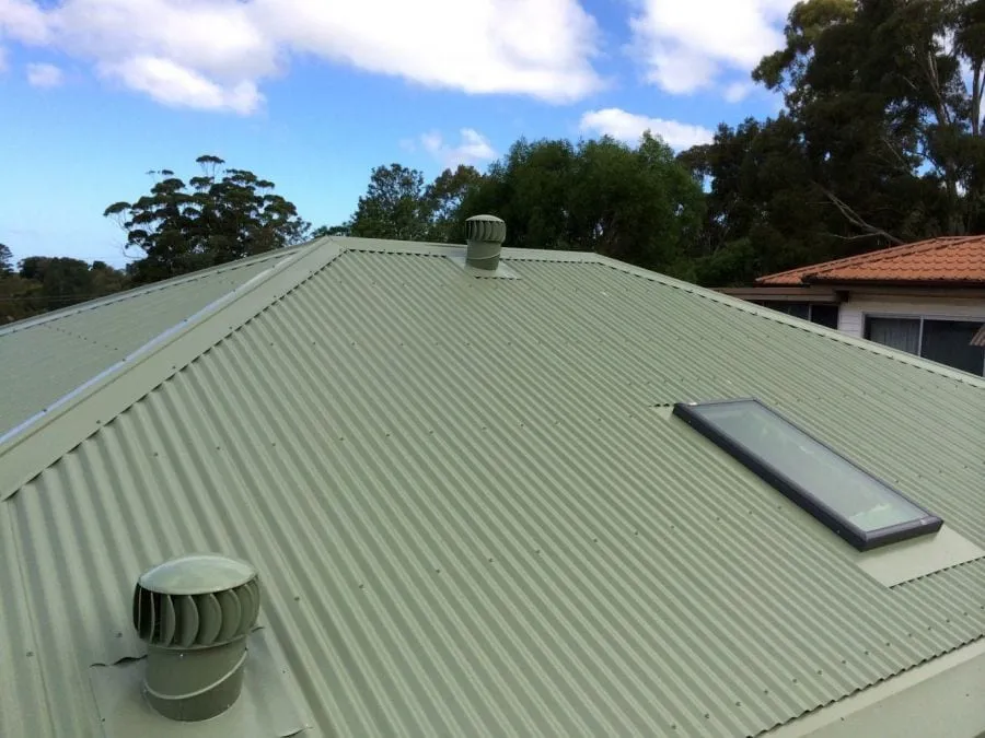 Sage-green COLORBOND metal roof with a skylight and whirlybird vents